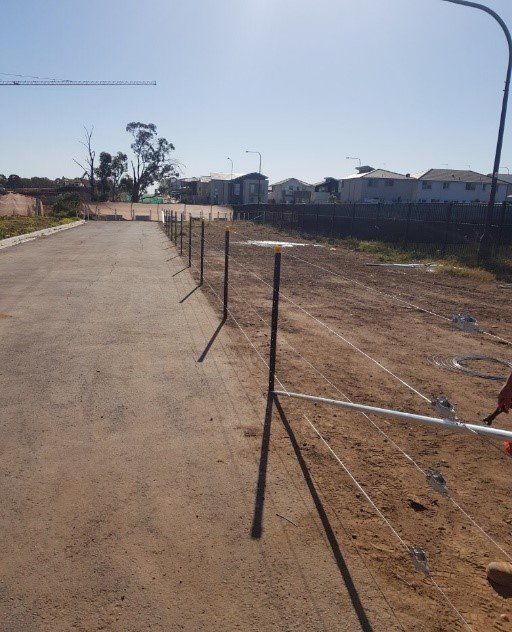 fence along dirty road
