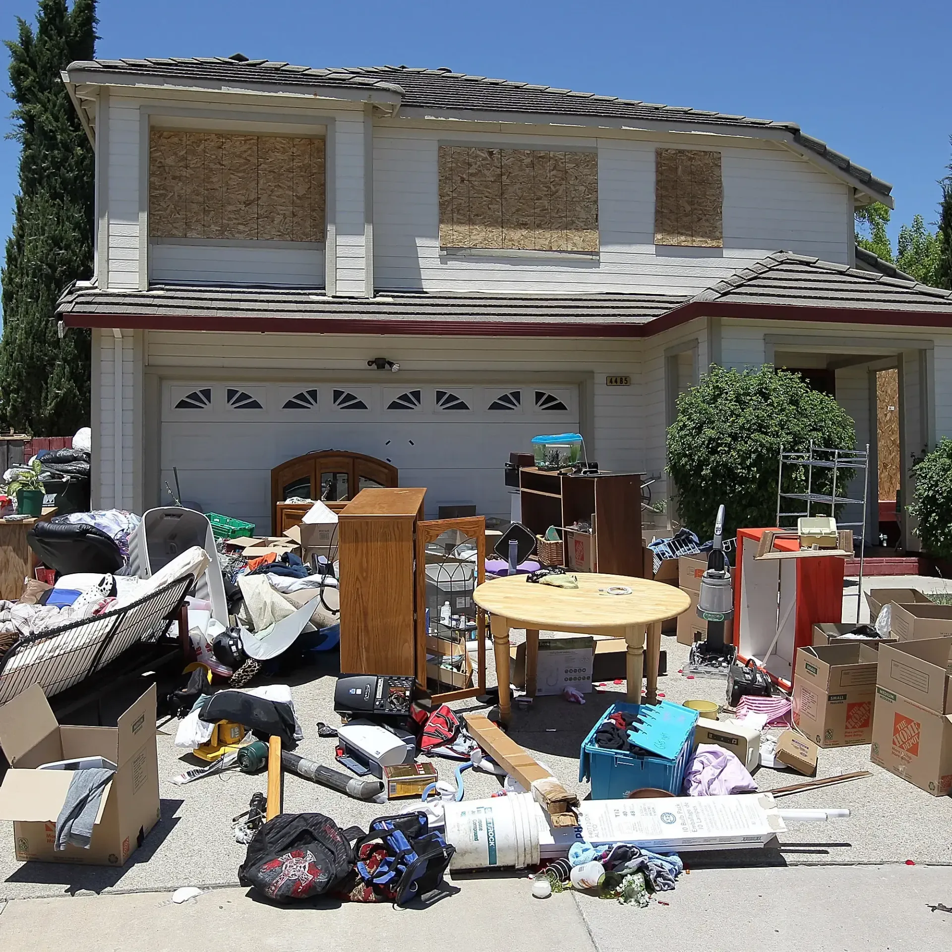 A house with a lot of junk in front of it