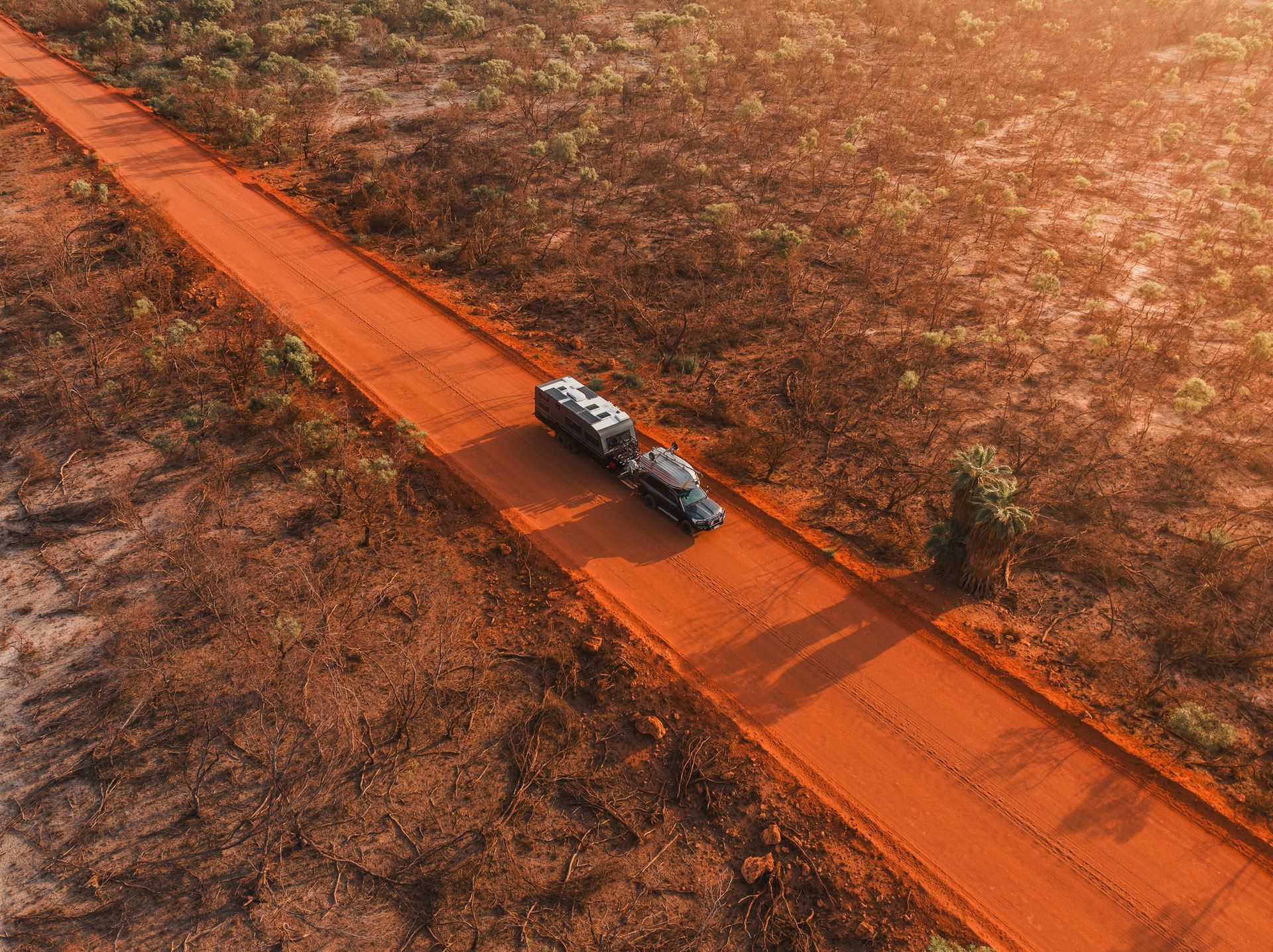 Vehicle towing a caravan on a dirt road, showing safe travel with brake controllers. Vehicle towing a caravan on a dirt road, showing safe travel with brake controllers.