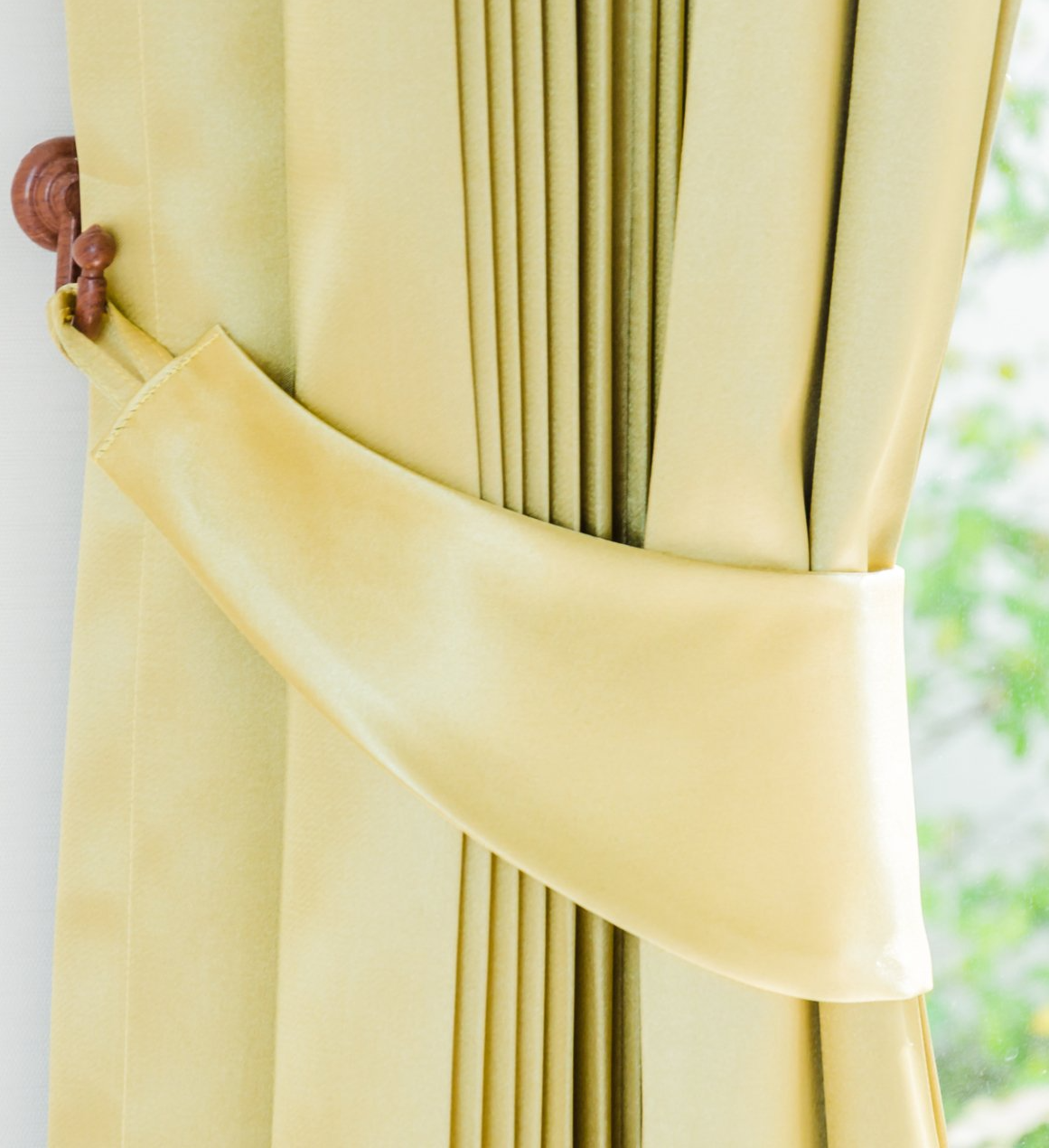 Close up of formal drapes, pulled to the side with hook tie-back.