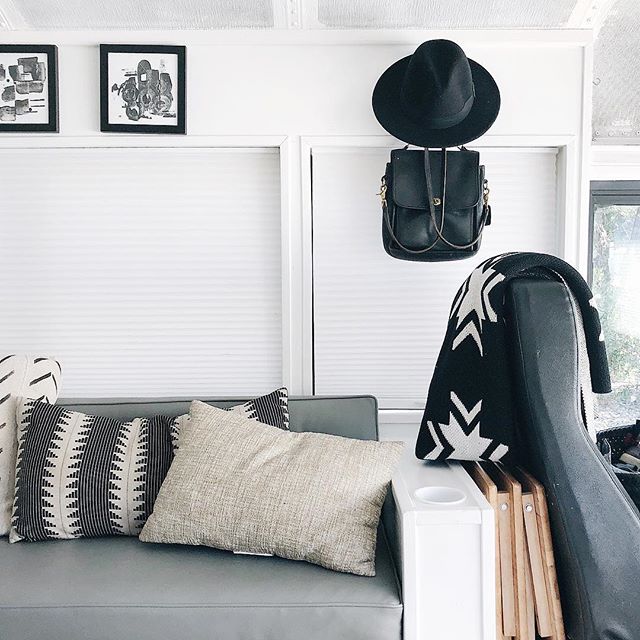 An image of the living space of the skoolie, designed with modern and minimalist decor as an example of how to make money on Instagram.