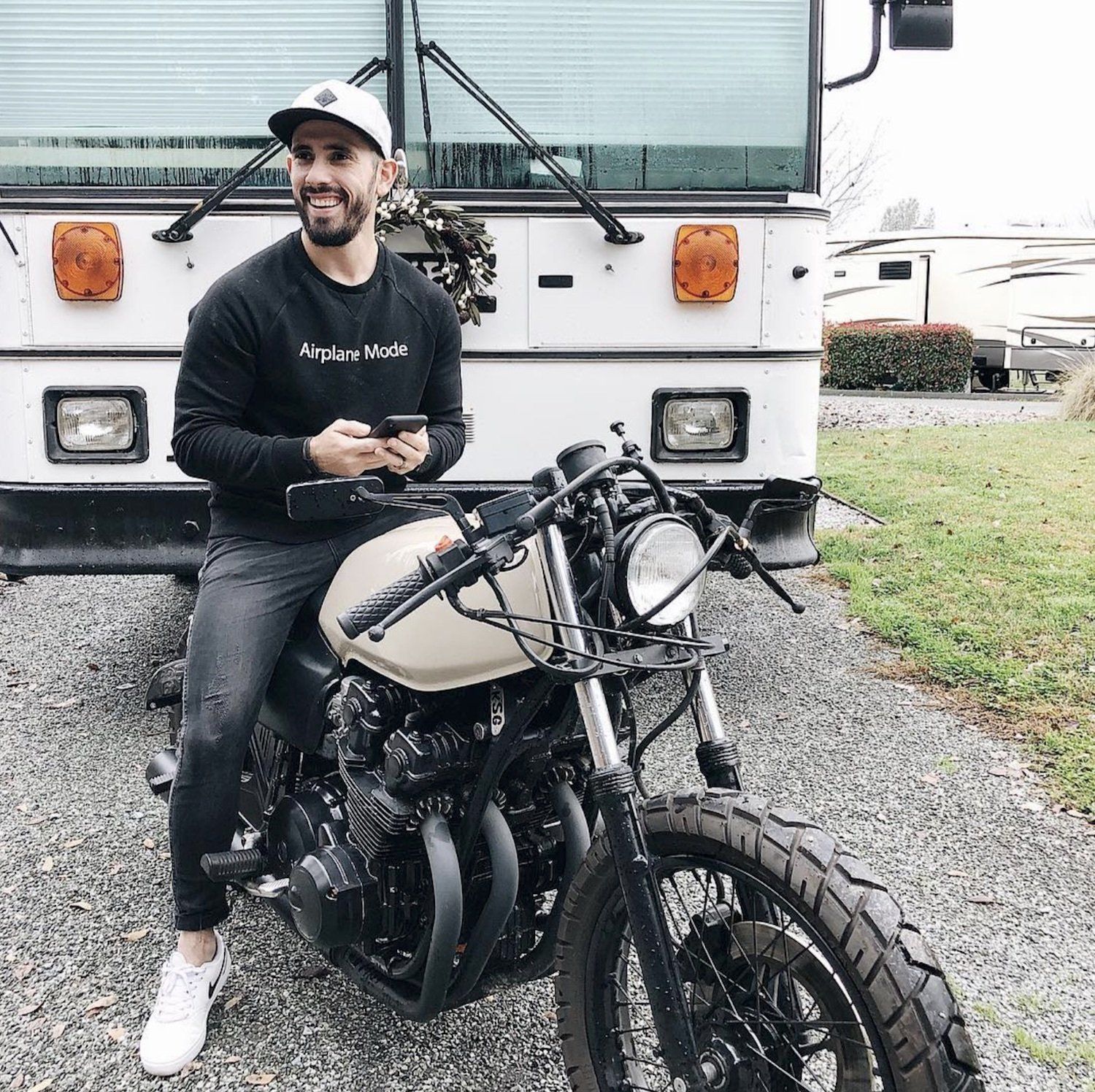 Gabriel Mayes sits on a motorcycle and smiles about the best time to post on Instagram.