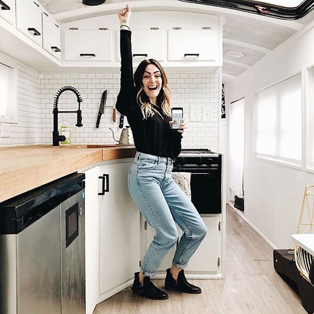 Debbie Mayes stands in the kitchen of the skoolie bus and celebrates what you need to build a 6-figure brand.