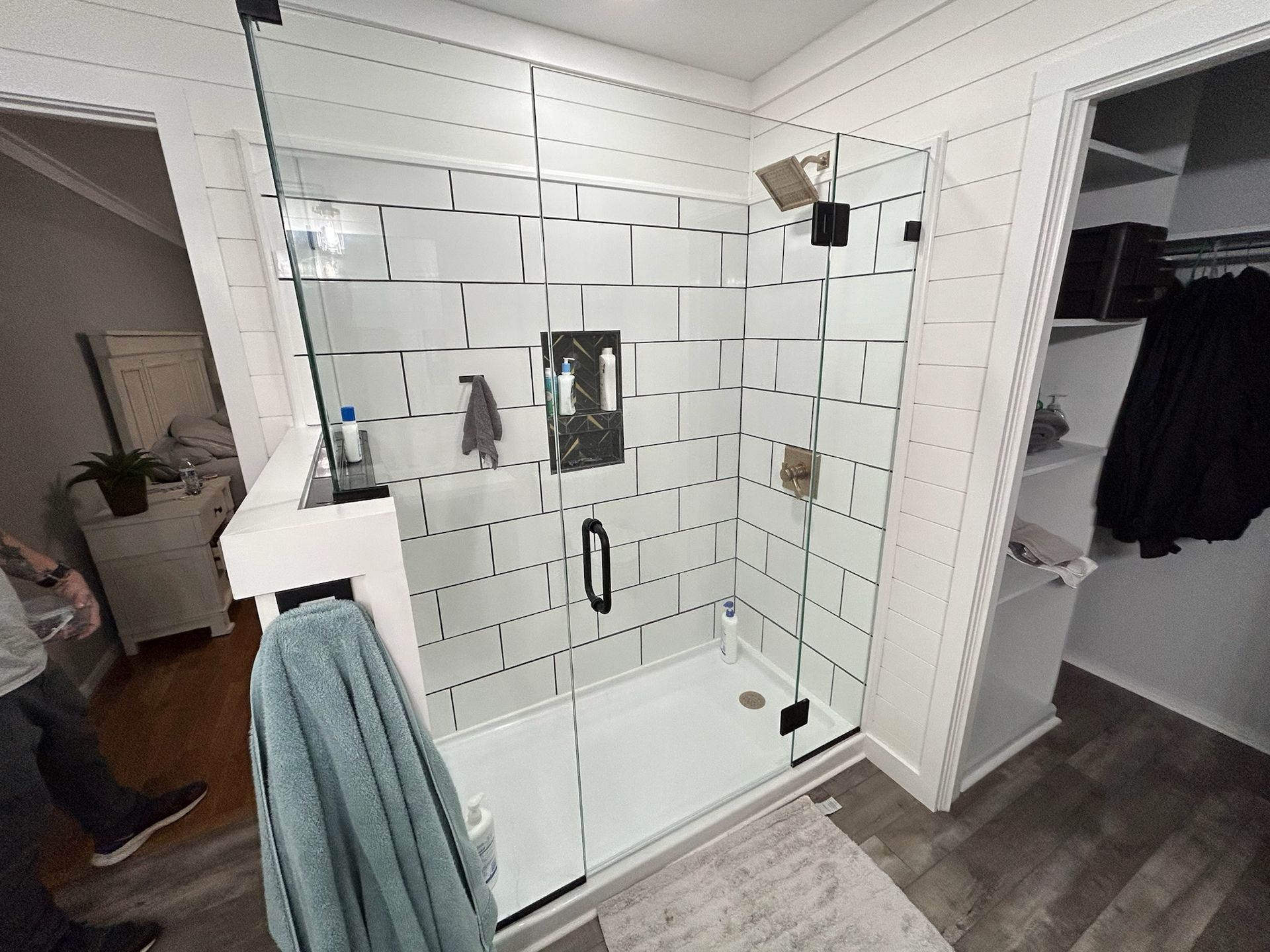 a bathroom with a walk in shower with a glass door