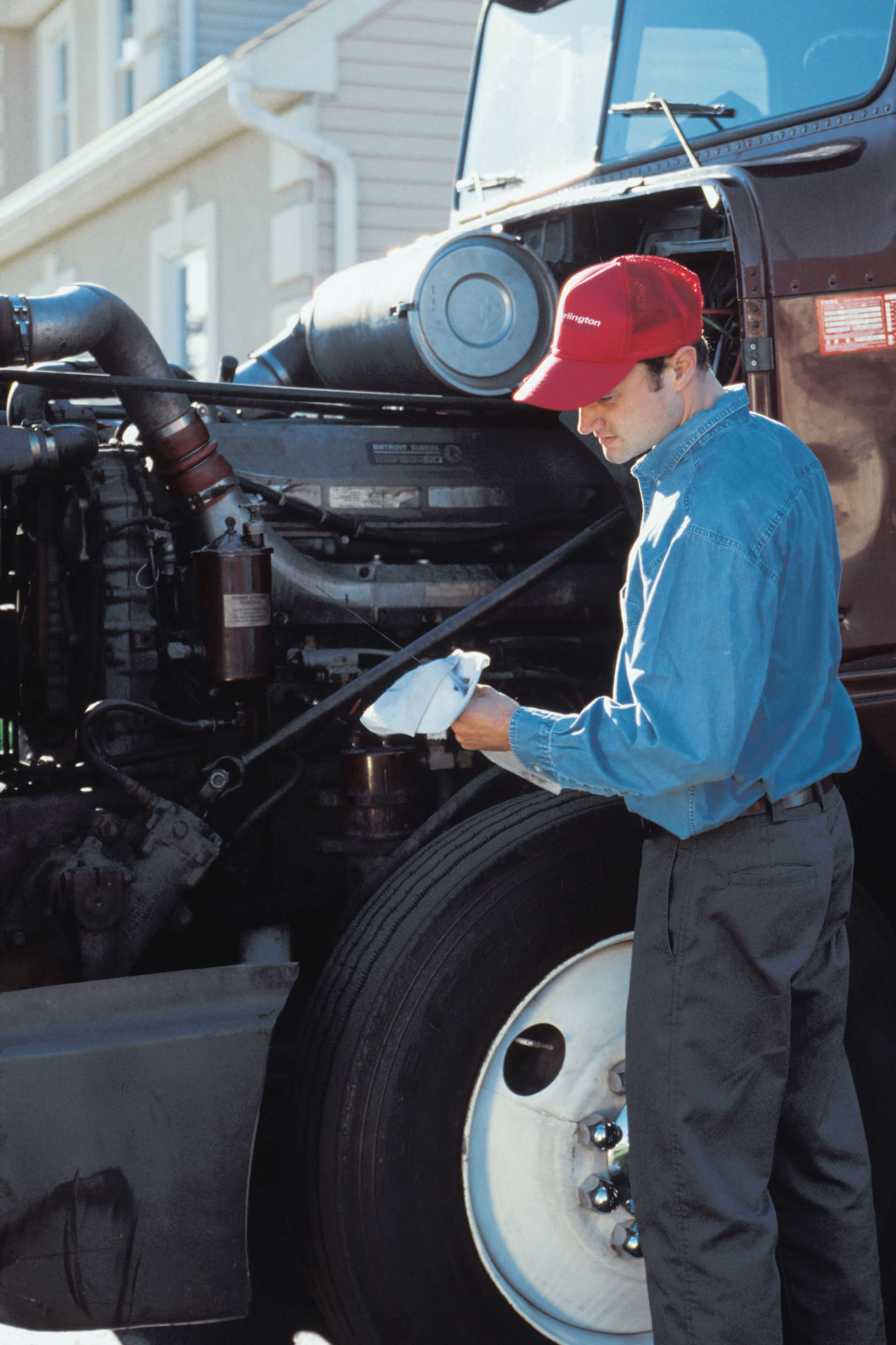Man servicing engine of semi- Auto Repair in Bay City, TX