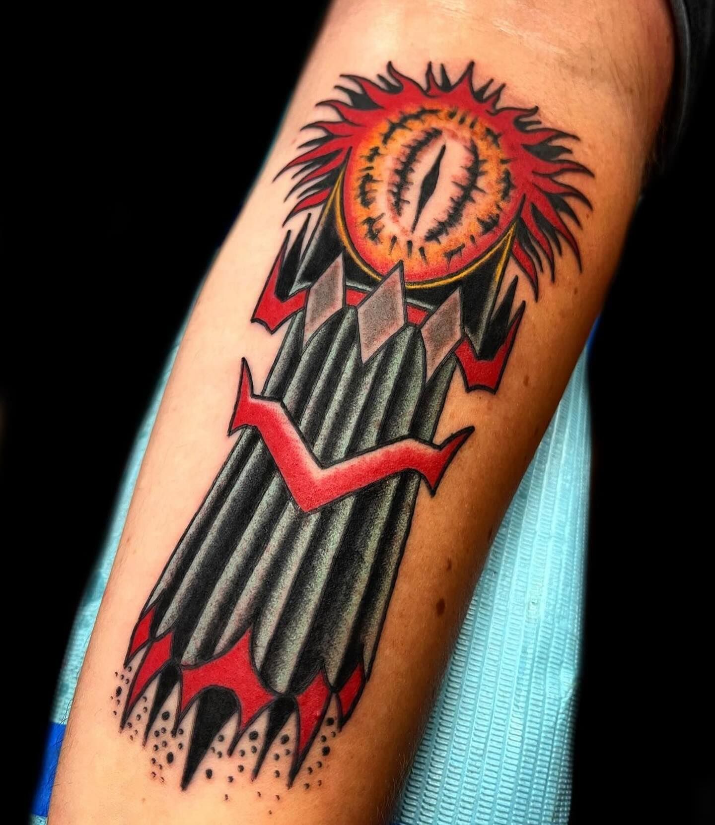 A tattoo on a person 's arm that looks like a rocket