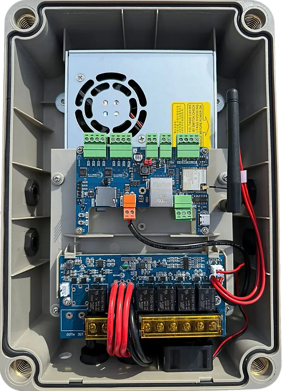 Lit-up white house with a dark roof and garage doors at twilight; green lawn and landscaping.