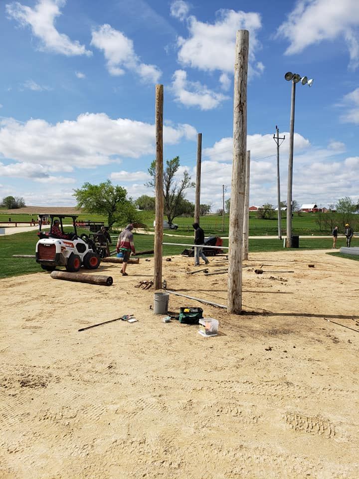 A group of people are working on a golf course.