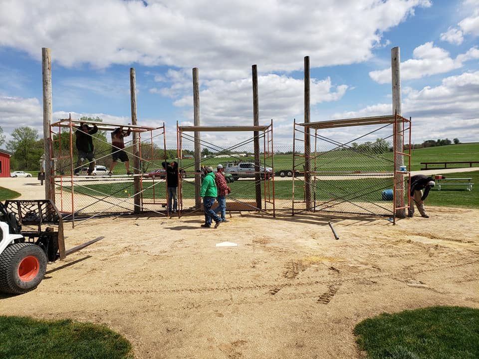 A group of people are working on a playground in a park.