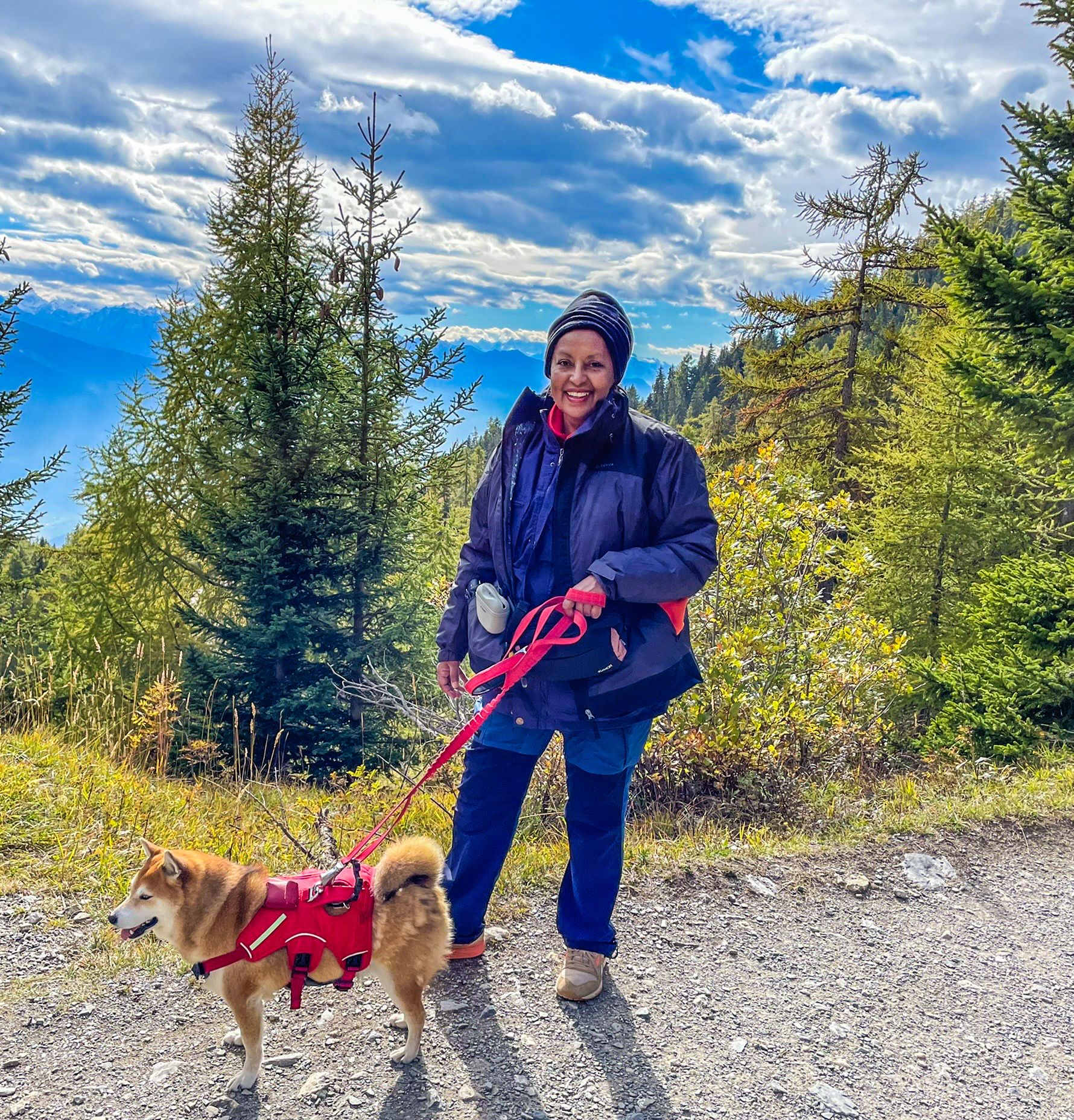 Saba Imru-Mathieu- walking her dog Kado, on a mountain path.

