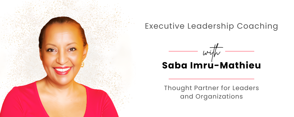 Saba Imru-Mathieu smiling in front of a sign that says executive leadership coaching