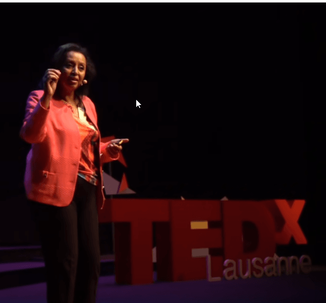 Saba Imru-Mathieu stands in front of a TEDx sign in Lausanne where she gave a talk.