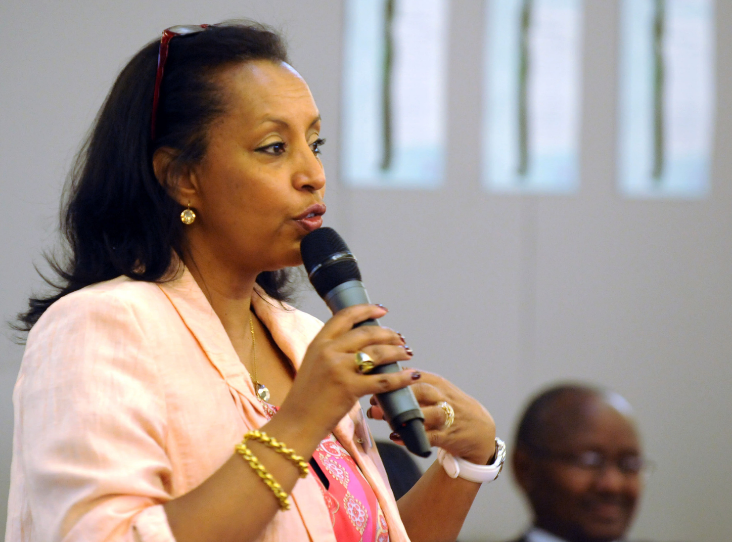 Saba Imru-Mathieu is speaking into a microphone