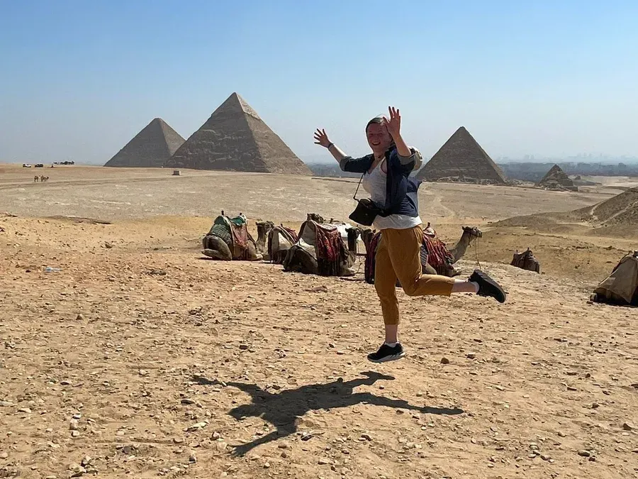 A Pyramids Land traveler at the Giza Pyramids on a private Egyptologist-guided Cairo day tour