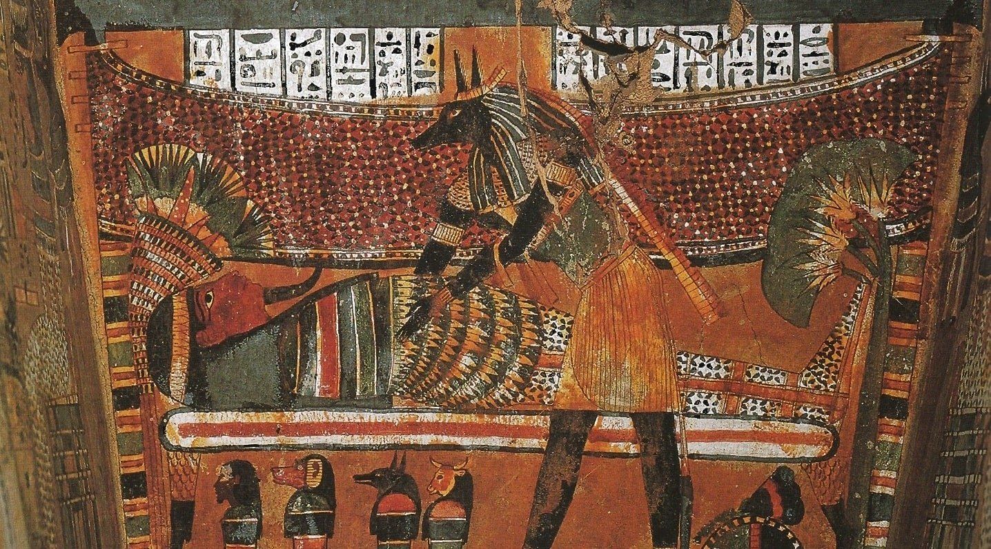 God Anubis mummifying a deceased