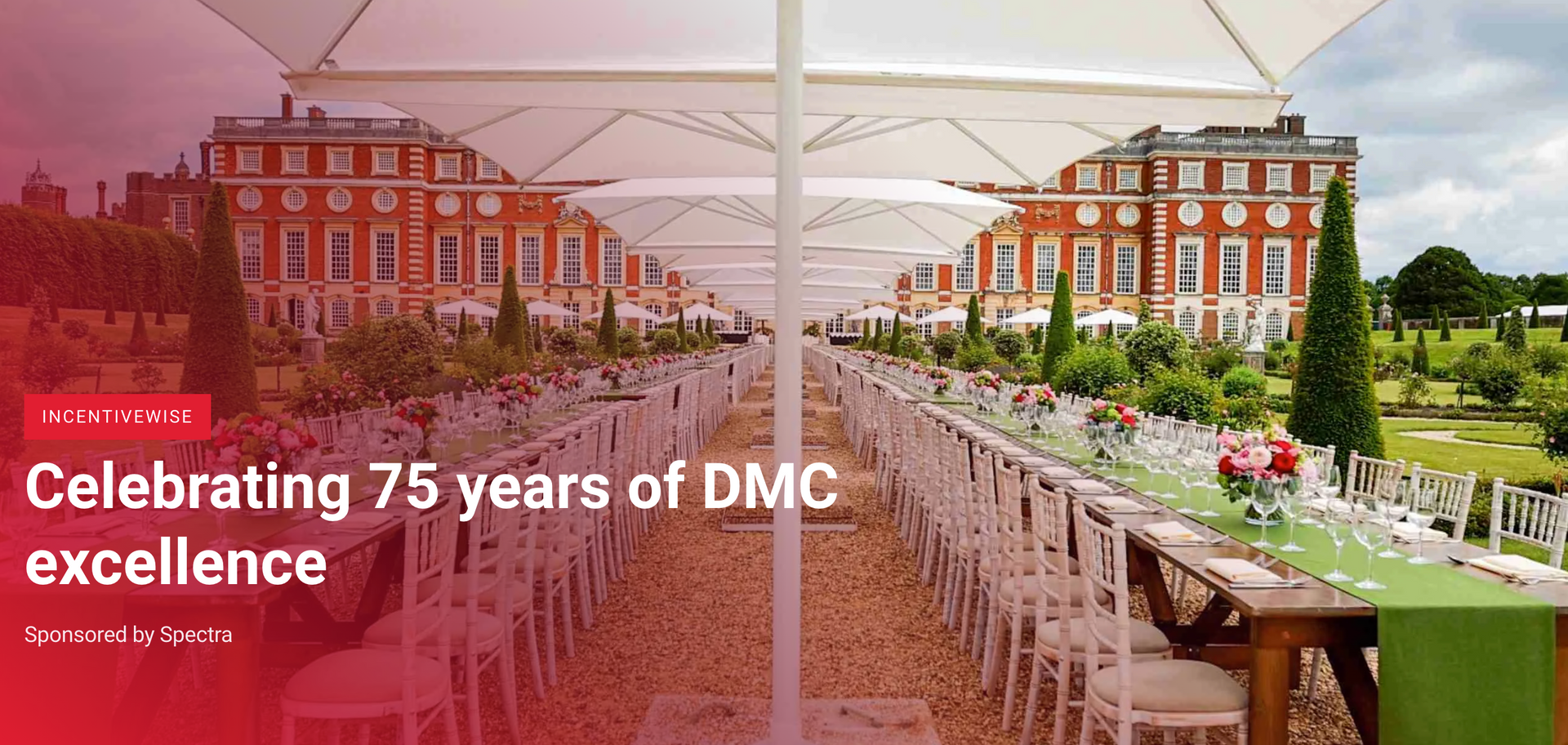 A long, outdoor dining table set under white umbrellas before a grand red brick building, with text celebrating 75 years.