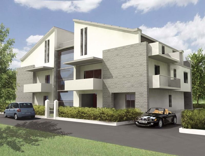 Moderno condominio con auto parcheggiate di fronte e verde circostante.