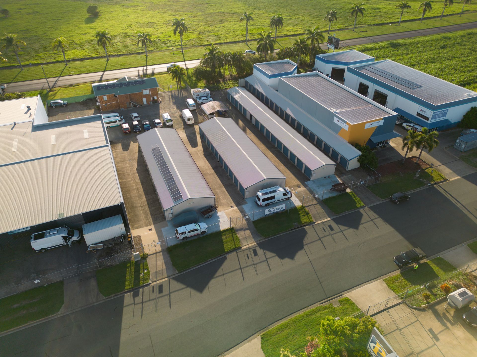 Metal Buildings with Palm Trees on A Sunny Street — Blue Ridge Self Storage In Paget, QLD