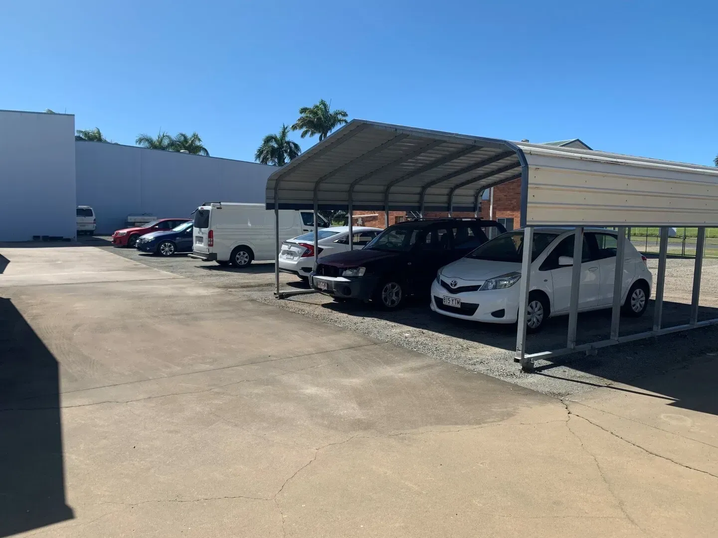 Cars Parked Under a Metal Carport, in A Parking Lot on A Sunny Day — Blue Ridge Self Storage In Paget, QLD