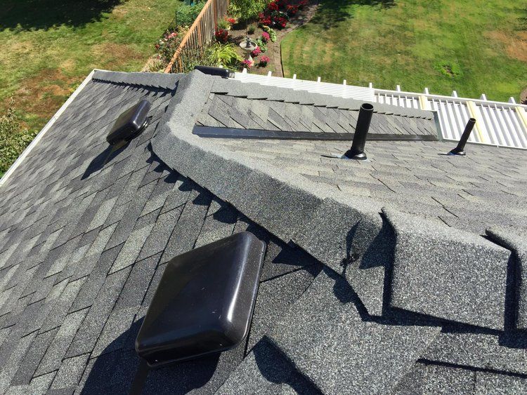 An aerial view of a roof with a few vents on it