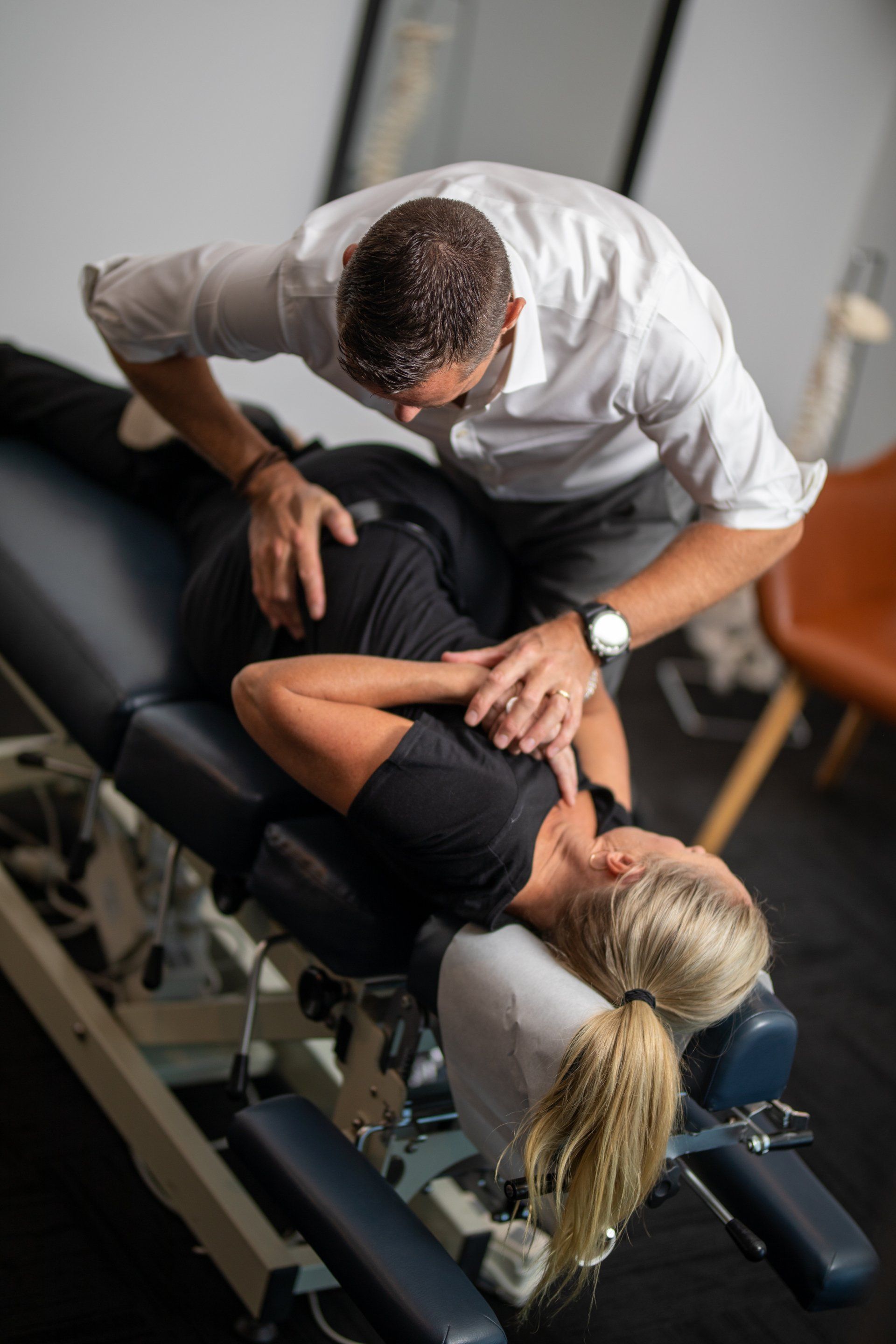 Chiropractor performing a spine adjustment