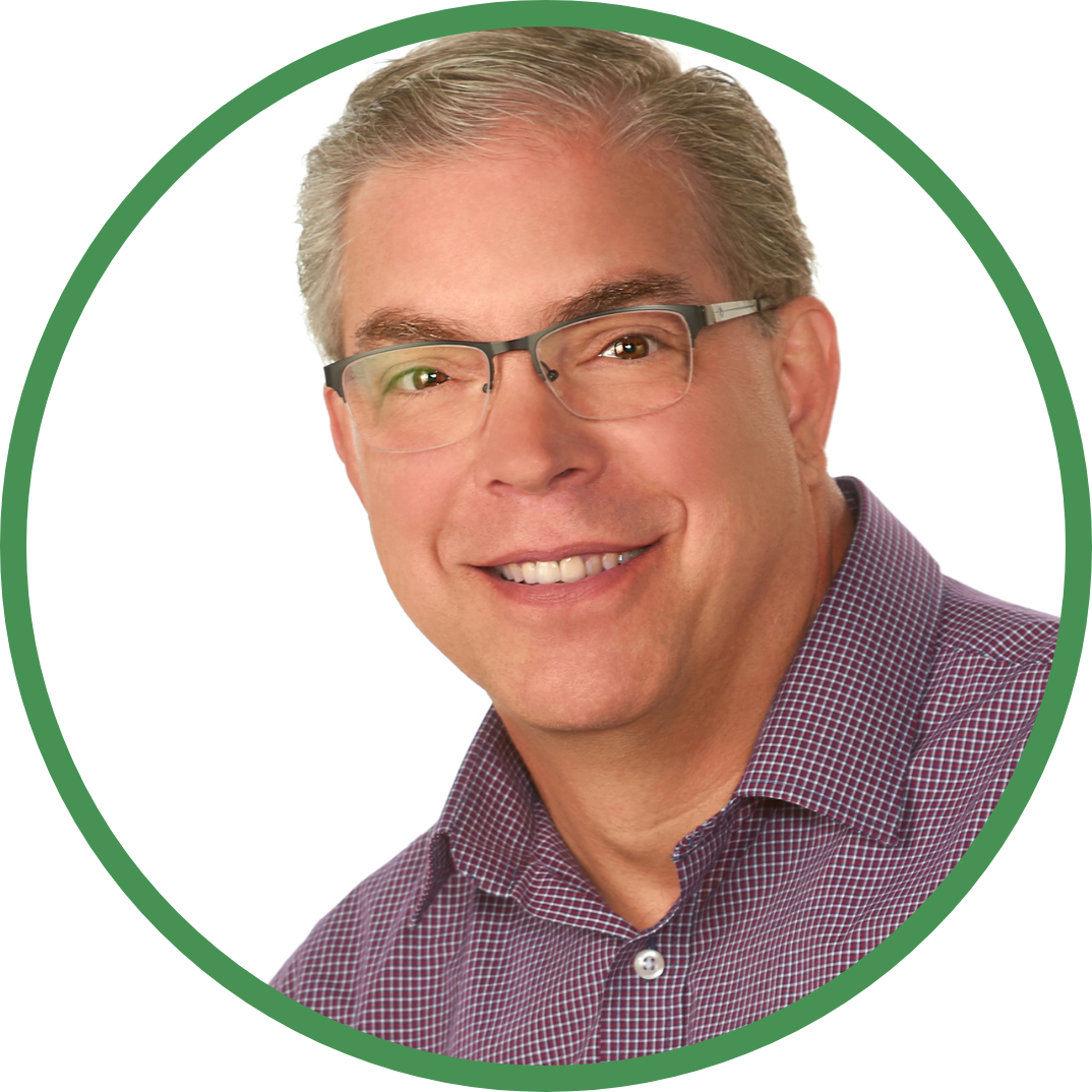 Smiling person with glasses in a purple checkered shirt inside a green circular border