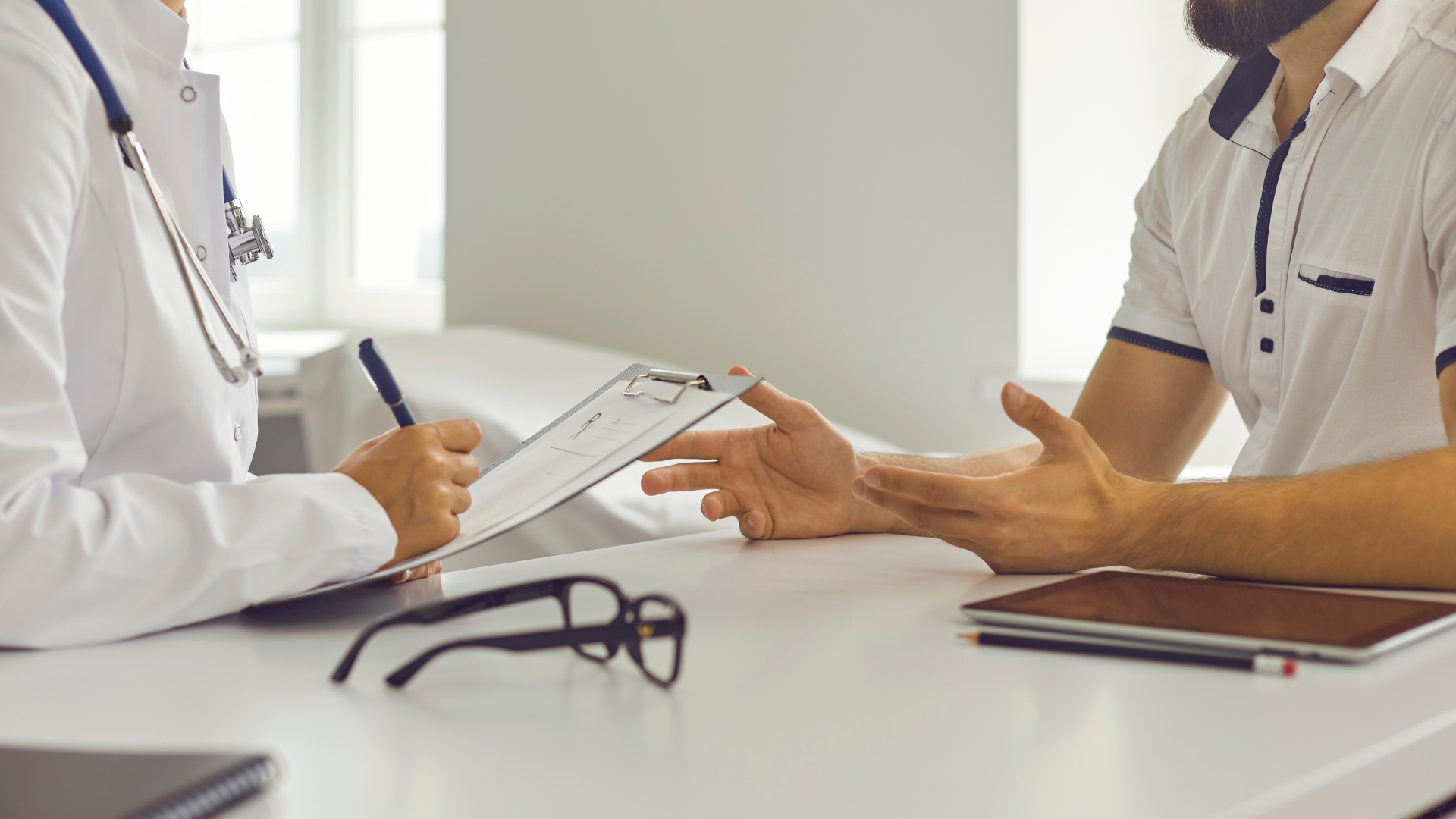 A nurse is listening to a little girl 's heartbeat with a stethoscope.