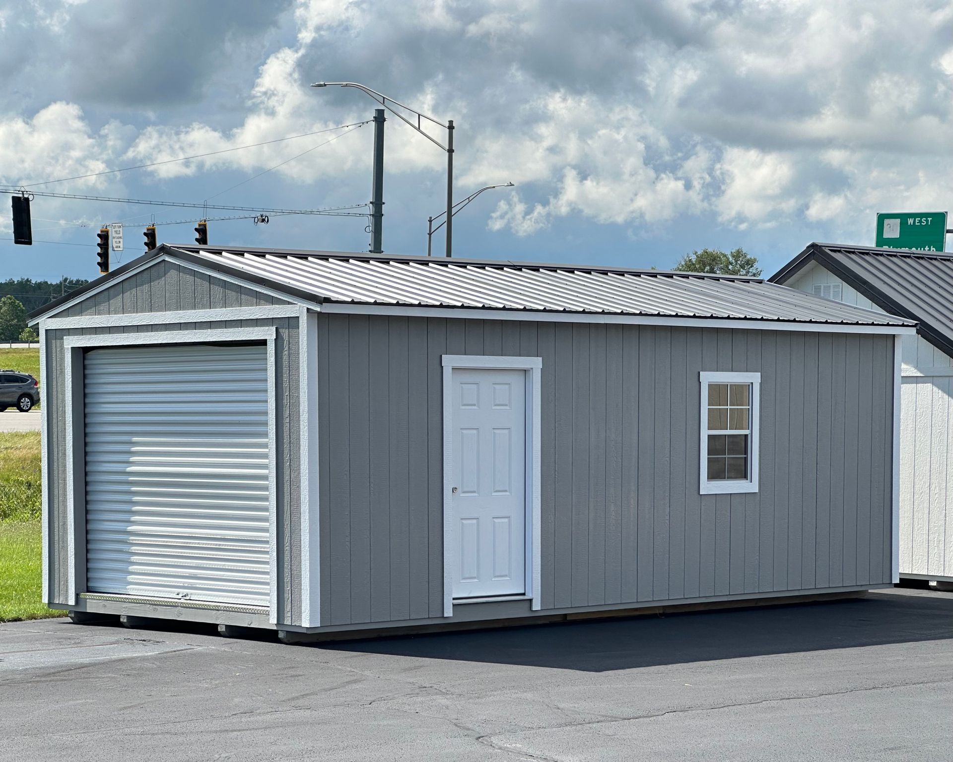 A gray garage with a white door and window