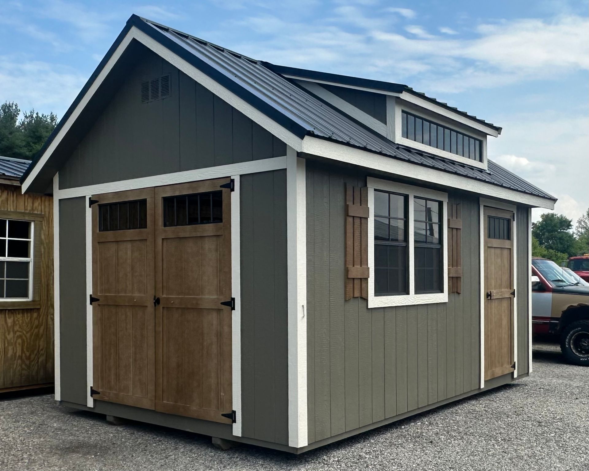 A small shed with a garage door and a window.