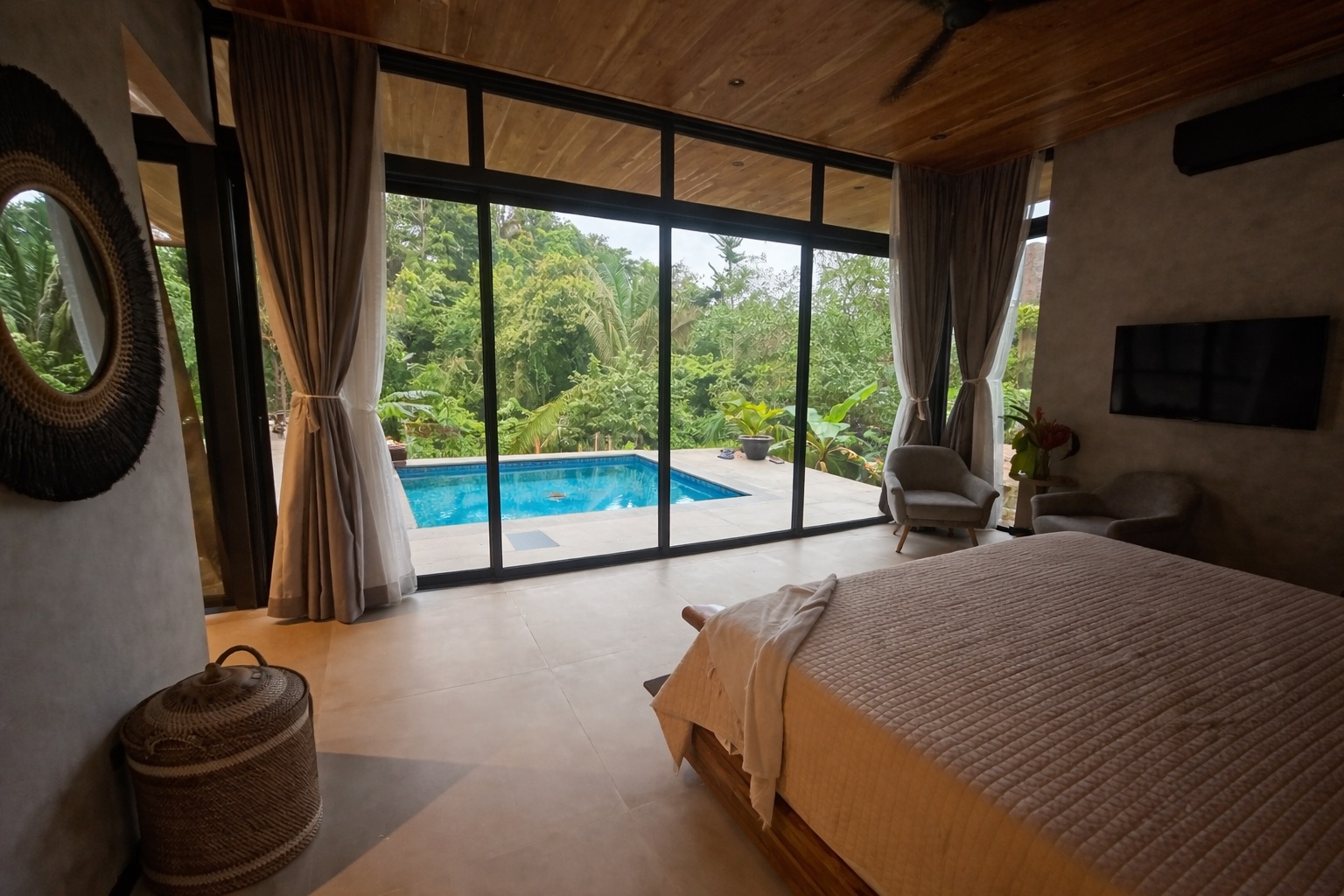 A bedroom with a bed , lamps , nightstands and a window.