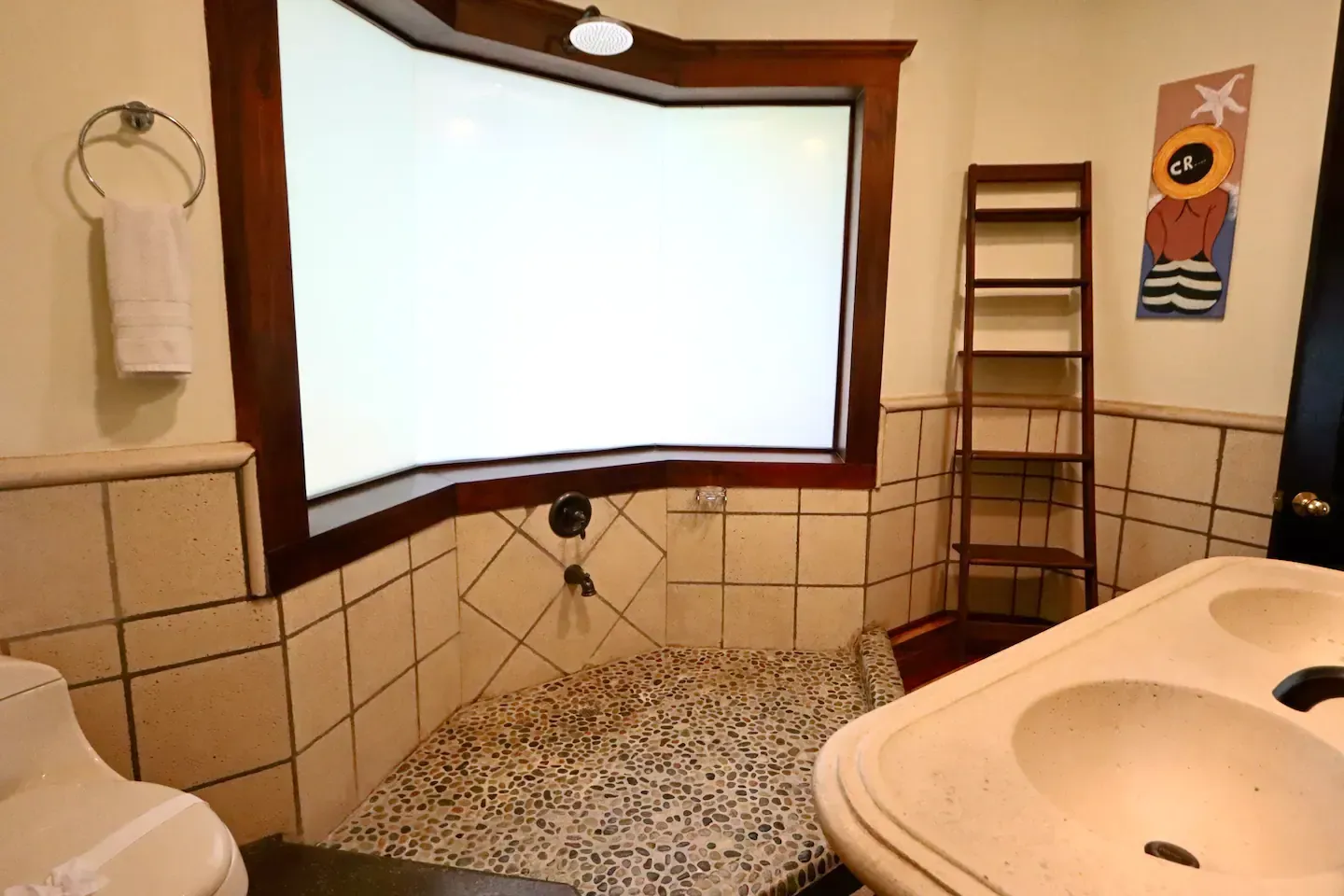 A bathroom with two sinks and a large window