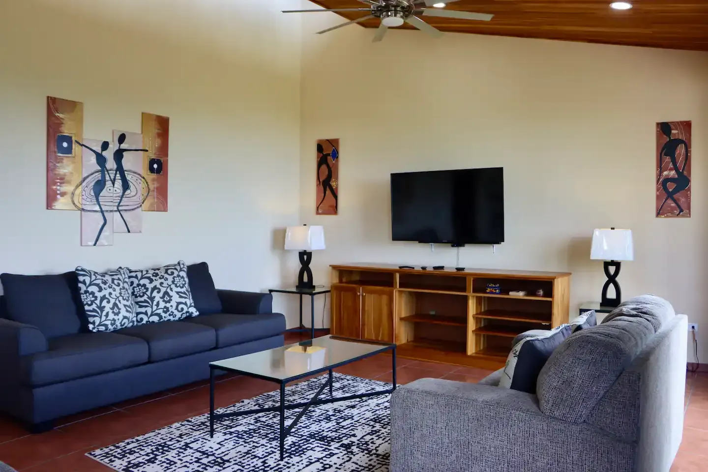A living room with two couches and a flat screen tv