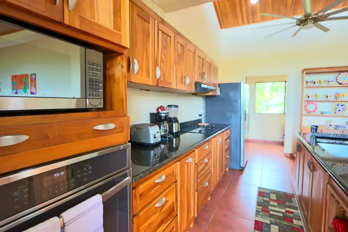 A kitchen with wooden cabinets and stainless steel appliances