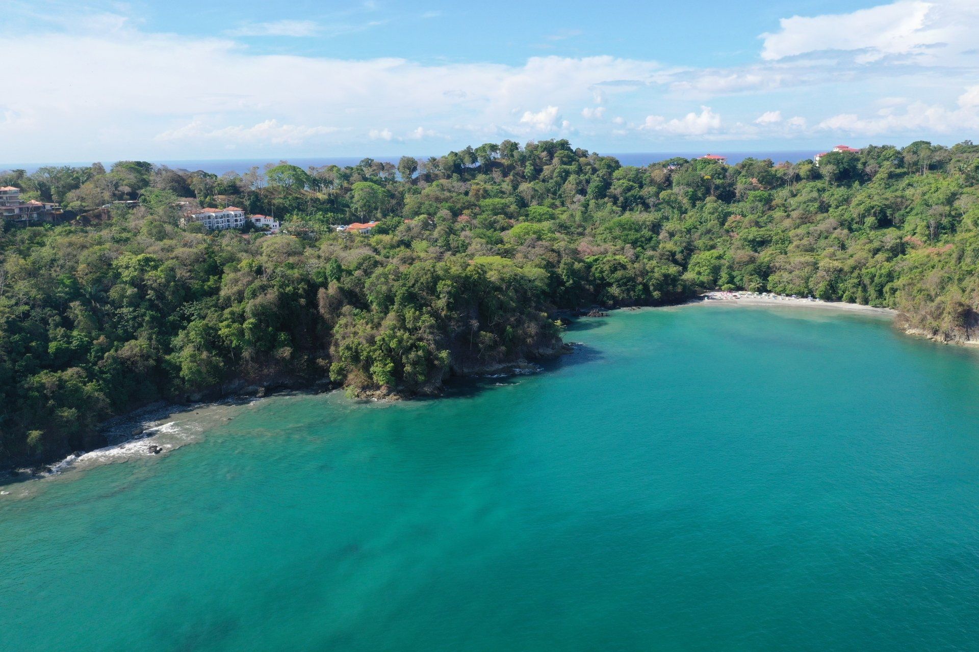 An aerial view of a large body of water surrounded by trees.