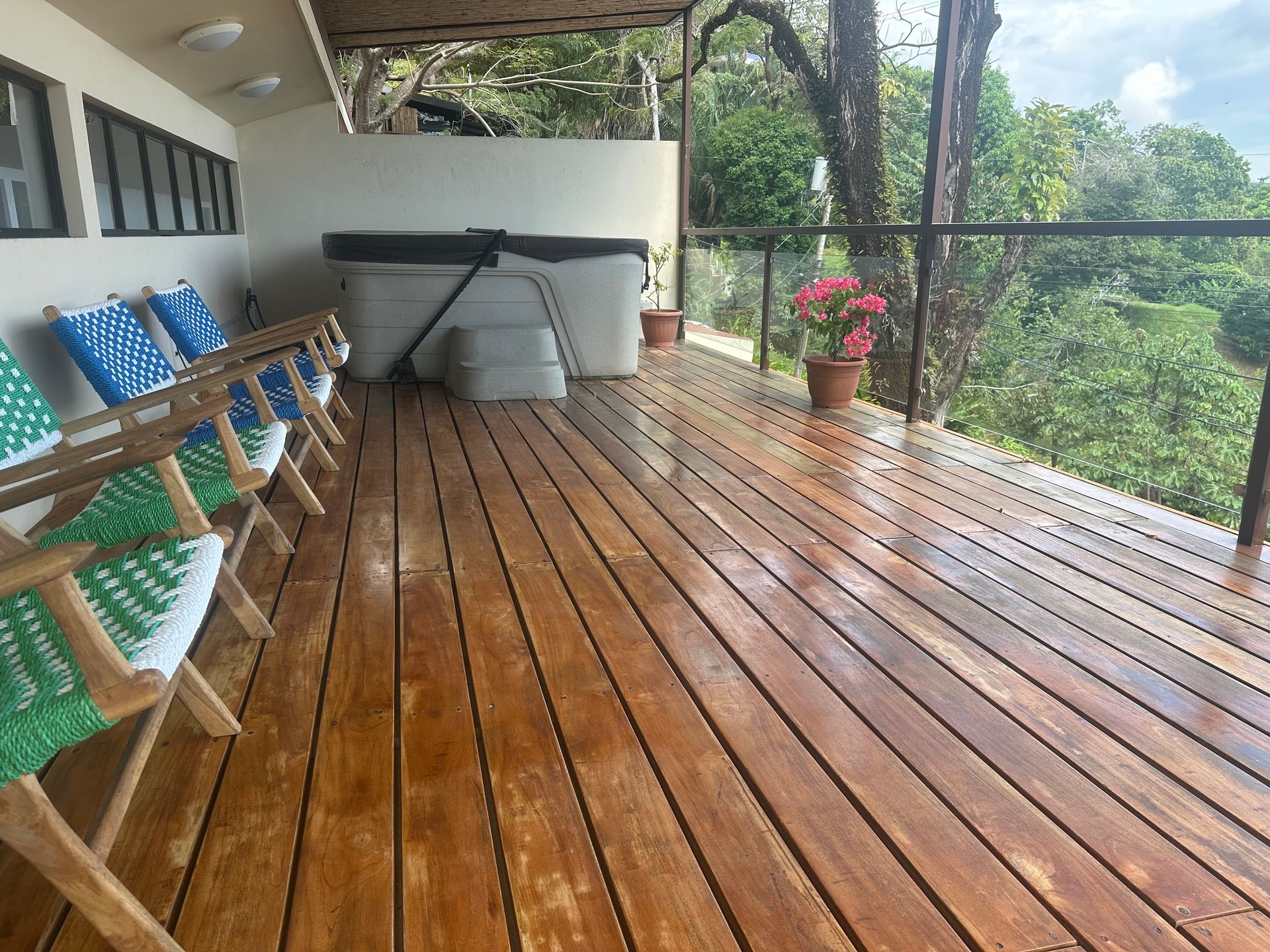 A wooden deck with chairs and a hot tub on it