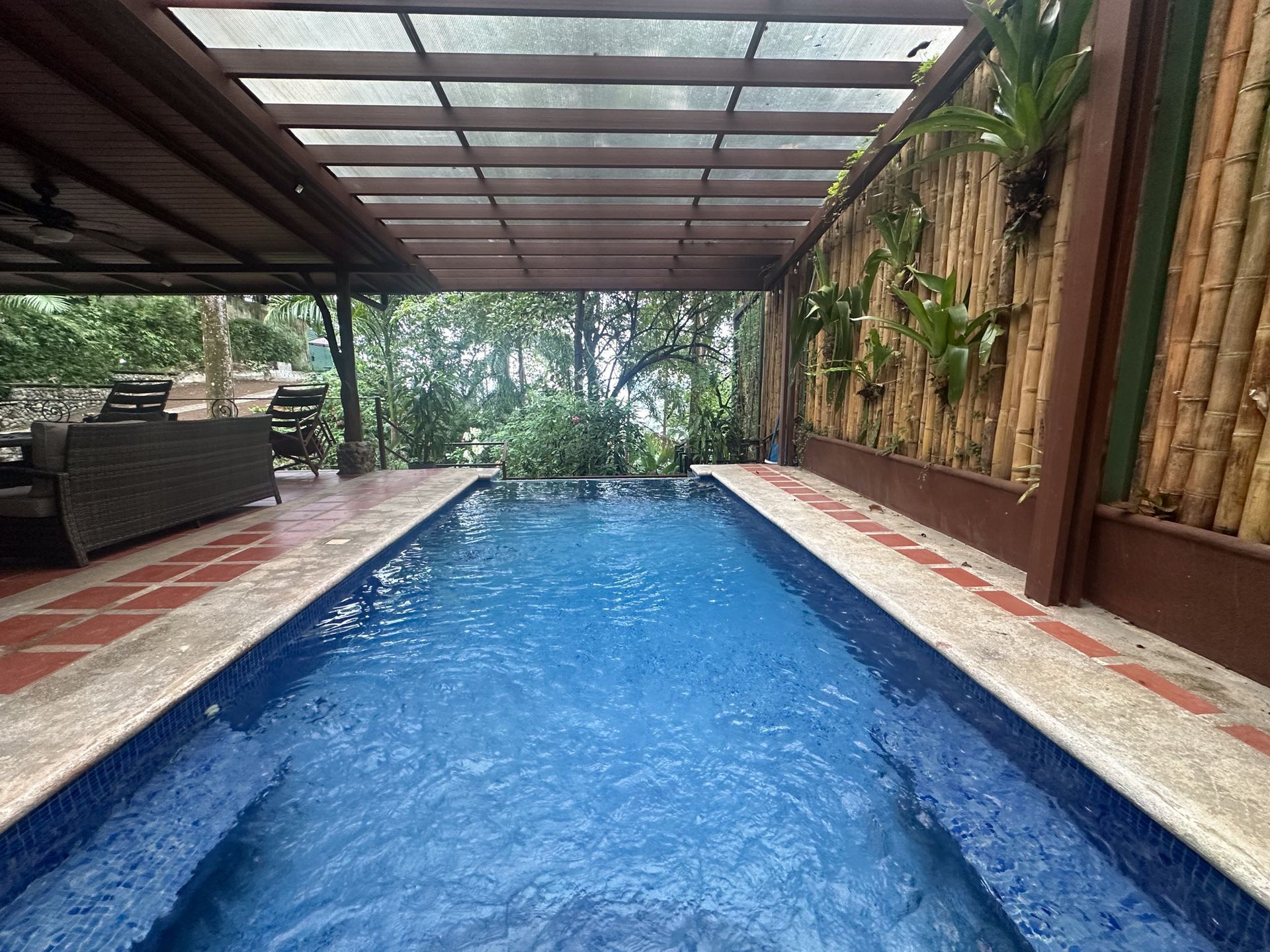 A large indoor swimming pool with a canopy over it.