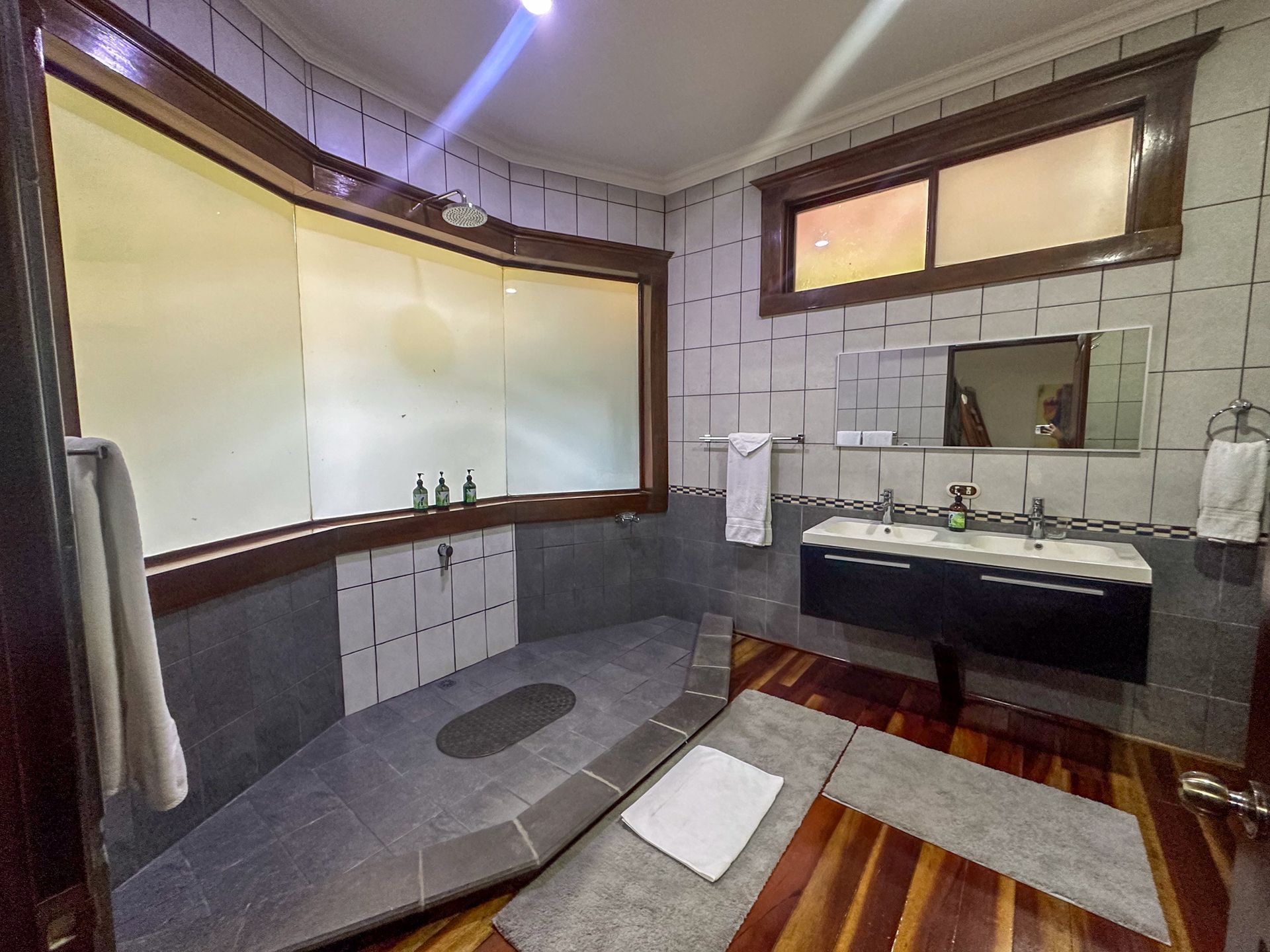 A bathroom with two sinks and a large window