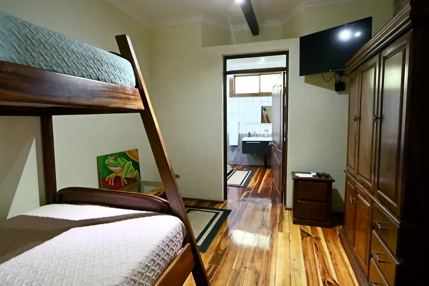 A bedroom with bunk beds and a flat screen tv