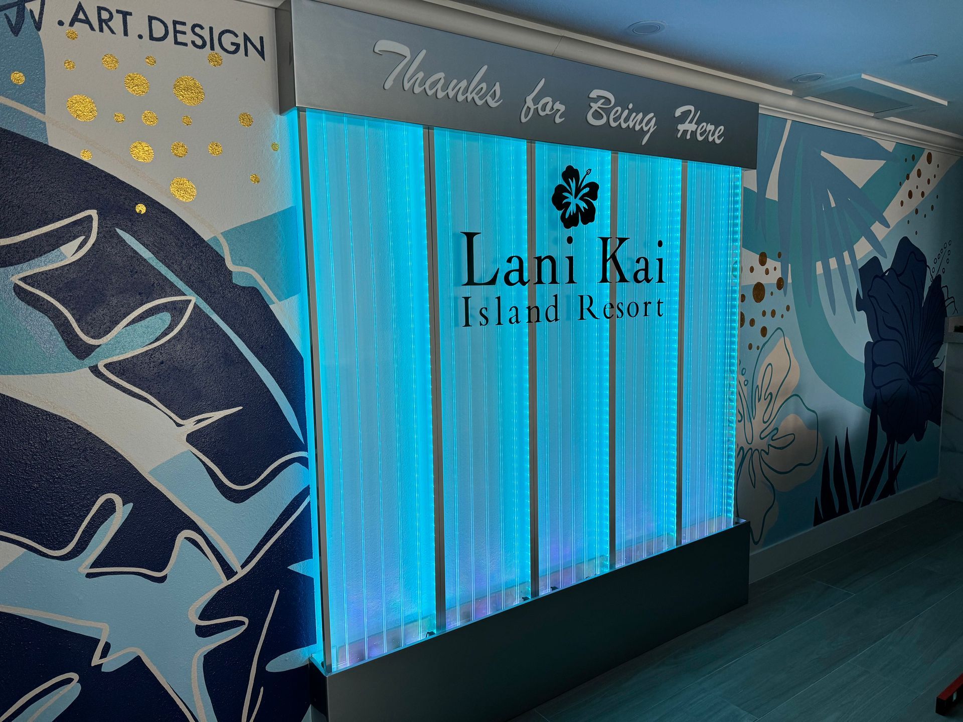 Lani Kai Island Resort sign with blue, illuminated waterfall backdrop