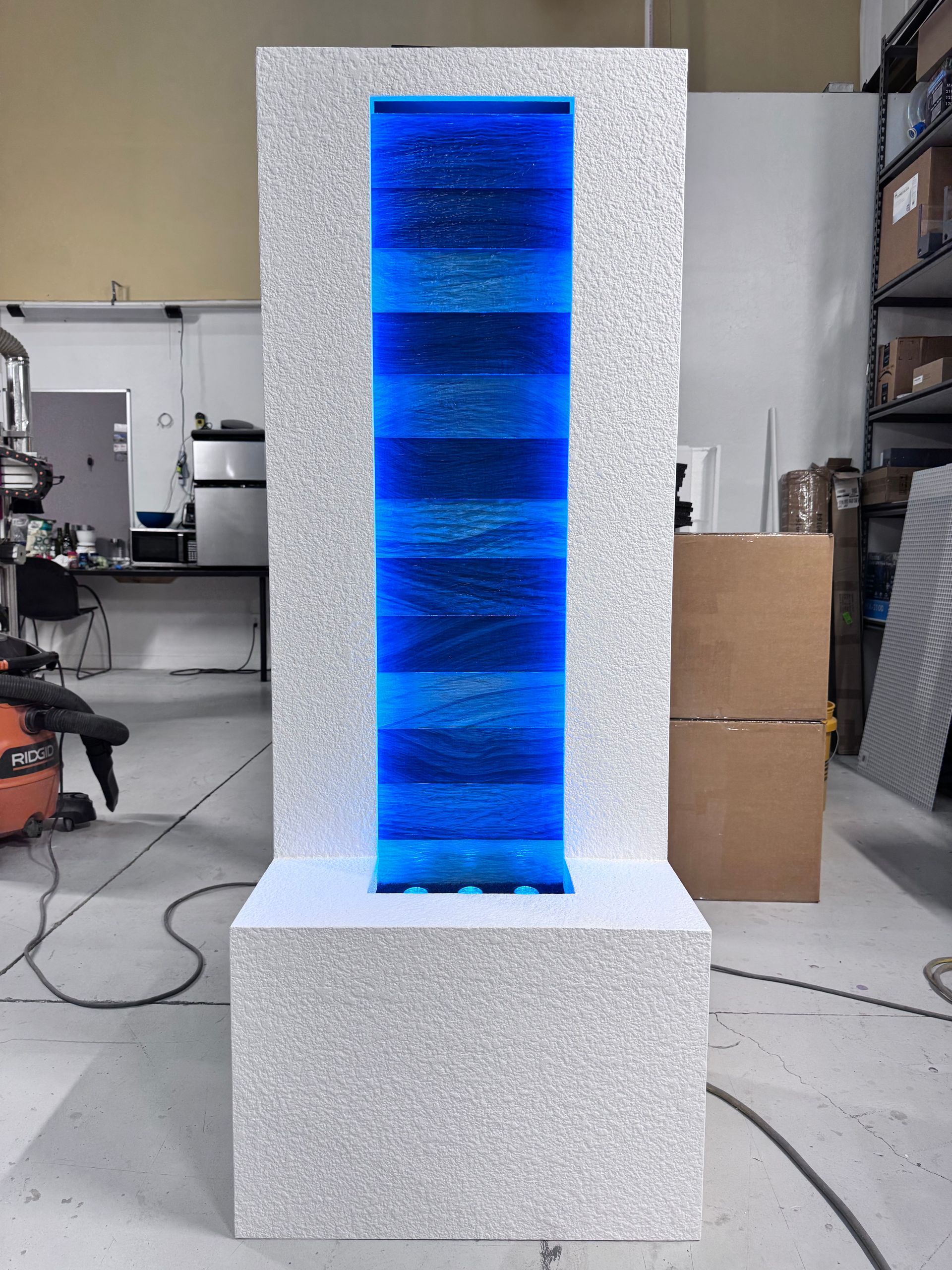 Water fountain with blue and silver accents, indoors