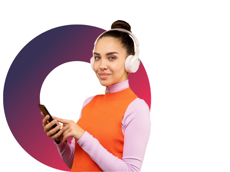 A woman wearing headphones is holding a cell phone.