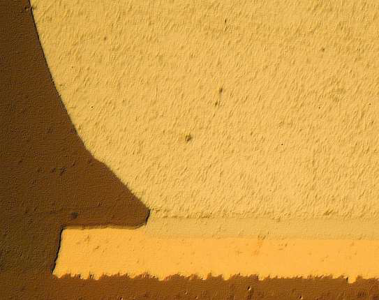 A microscopic cross-section showing a gold-colored solder joint connecting to a metallic layer on a dark substrate.