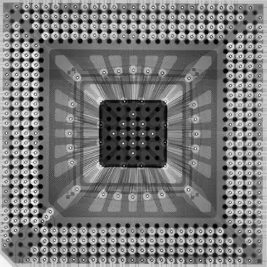X-ray of a square microchip, showing internal connections and solder ball grid array.