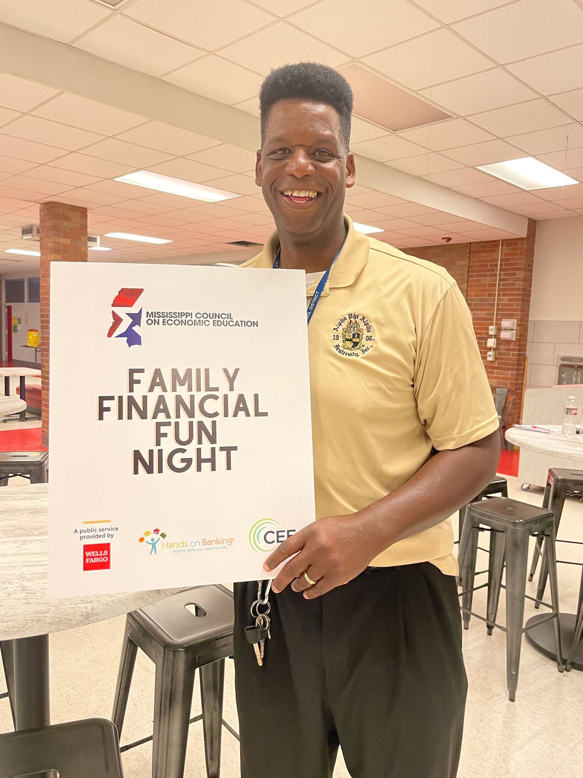 A man is holding a sign that says family financial fun night.