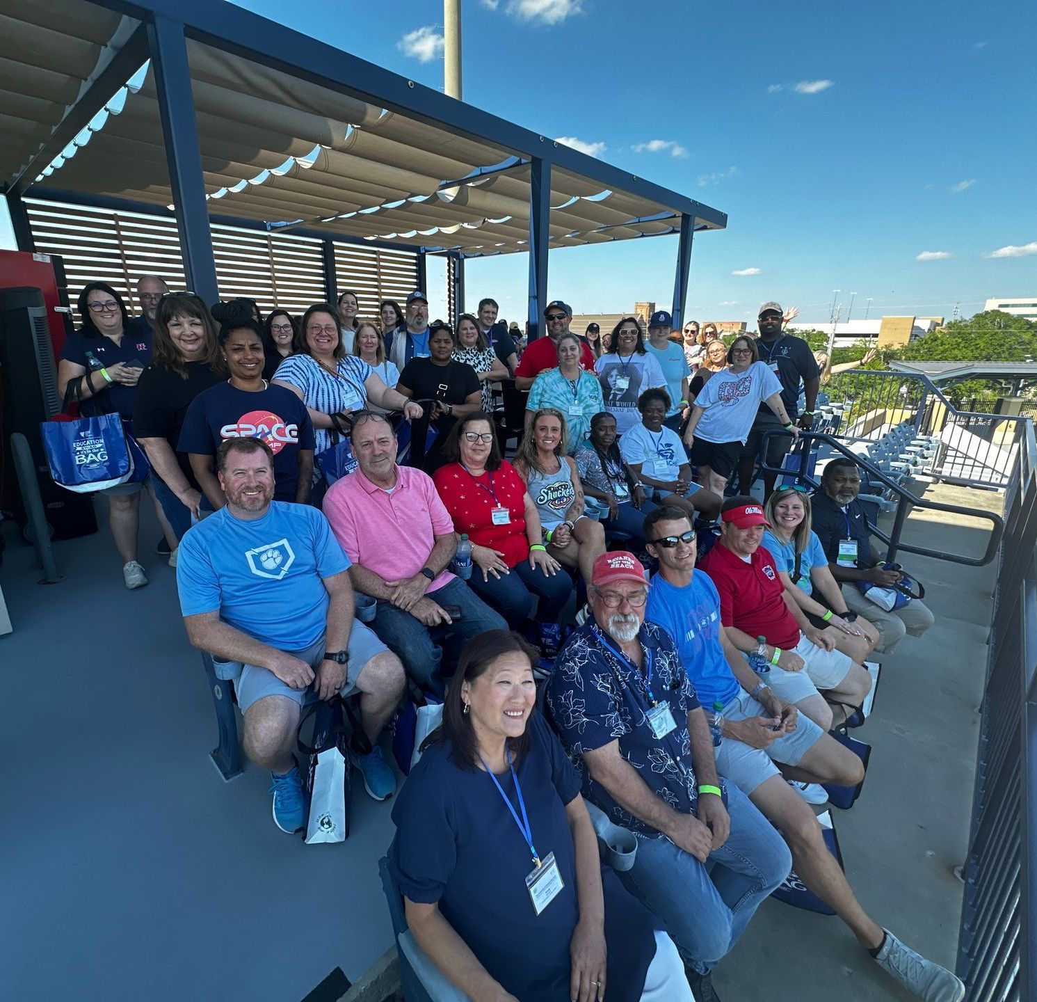 A group of people are sitting on a balcony.