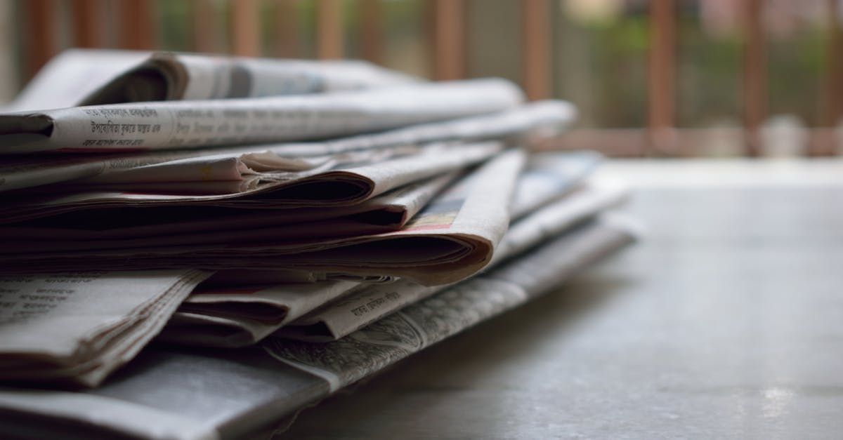 A stack of newspapers is sitting on a table.