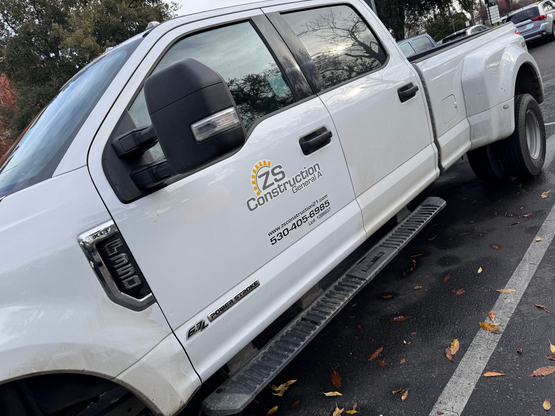 A white pickup truck is parked in a parking lot.