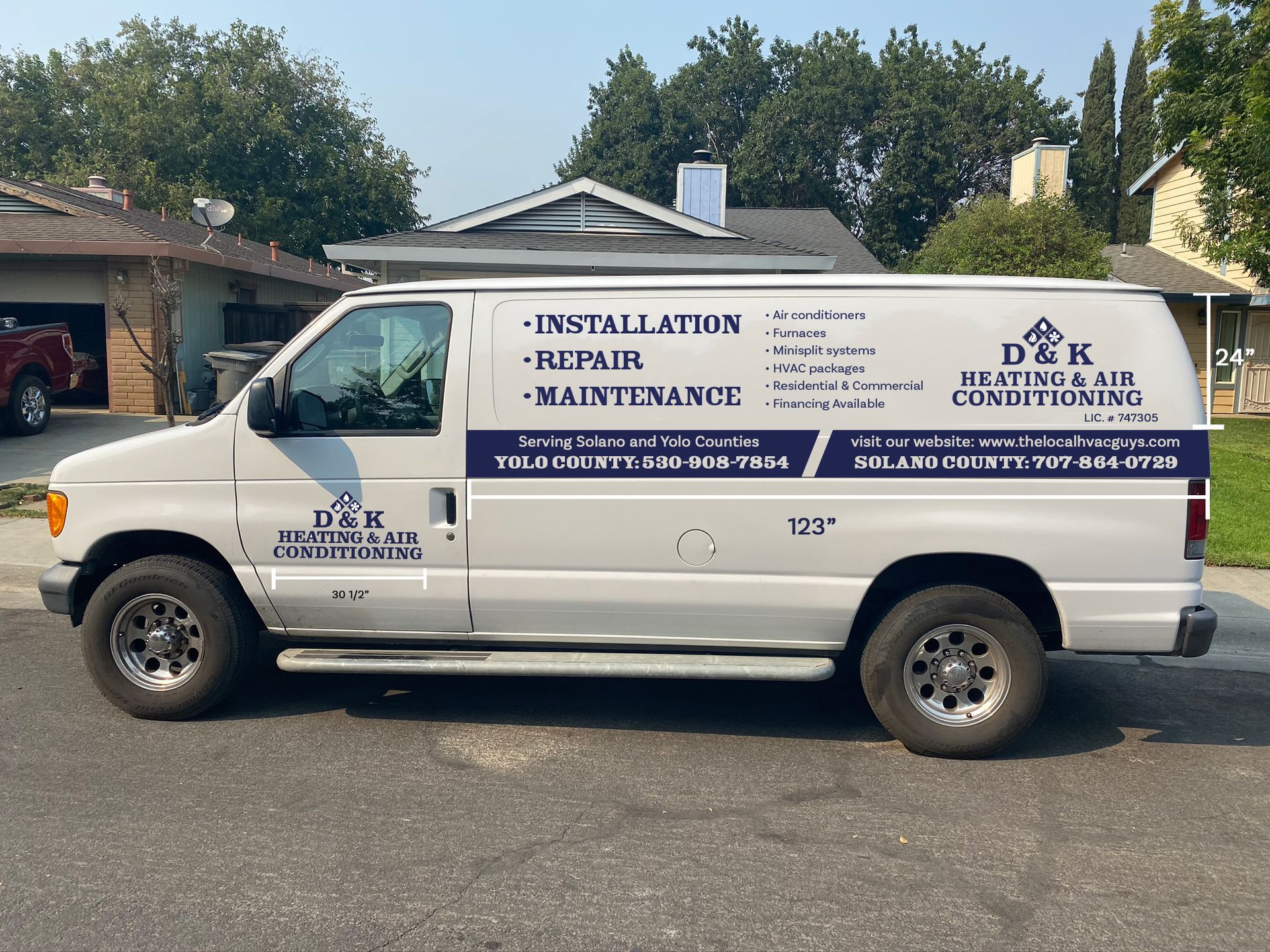 A white van with d & k written on the side is parked in front of a house