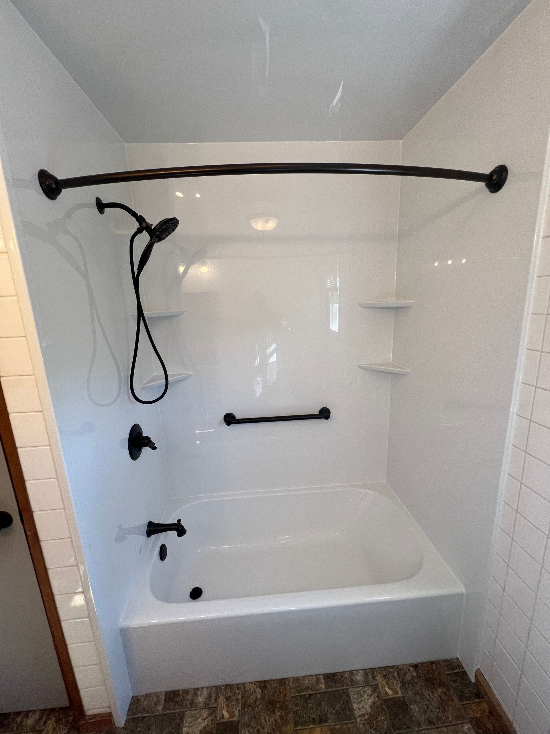 A bathroom with a bathtub and a shower.