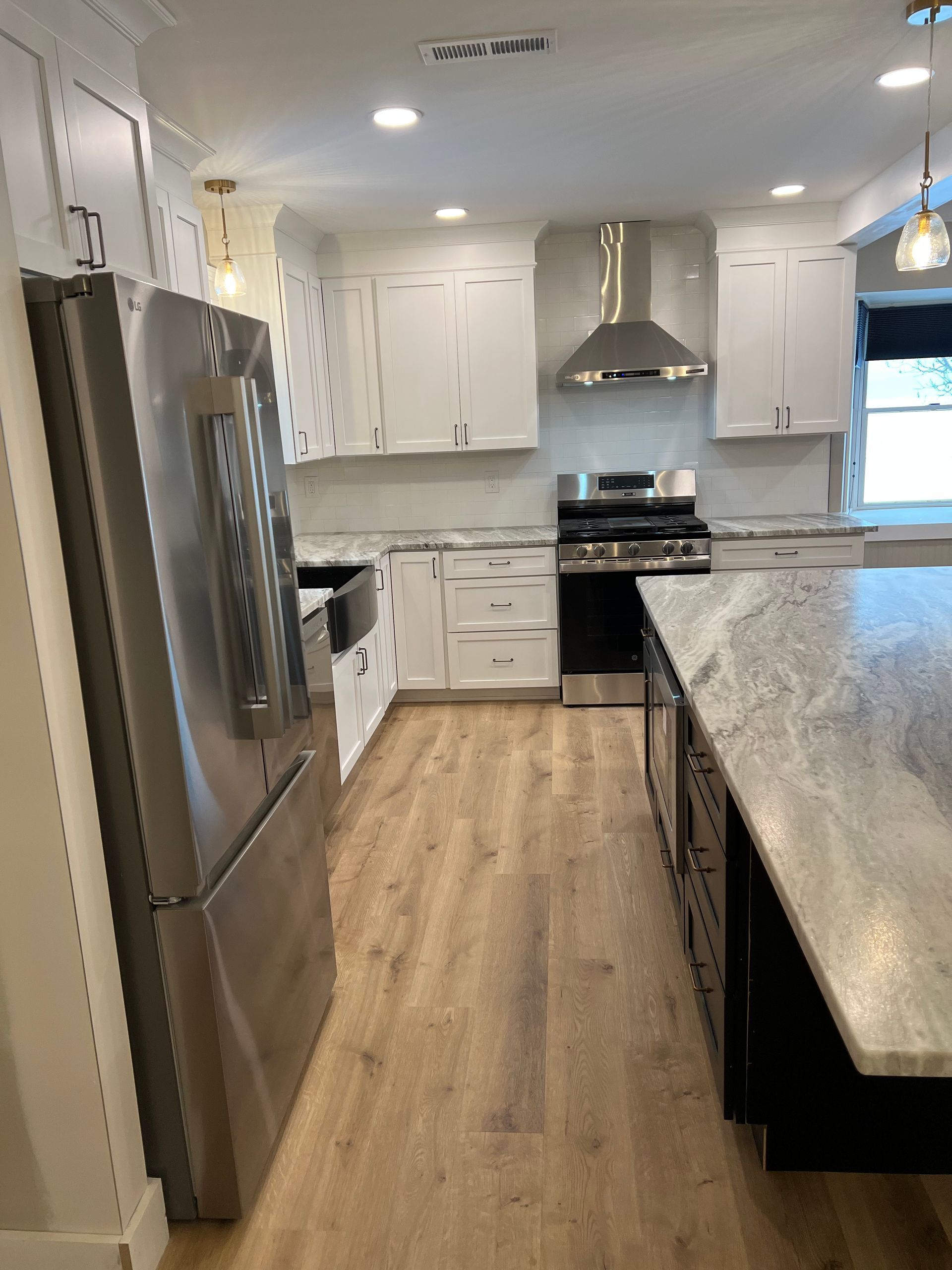 A kitchen with stainless steel appliances and white cabinets